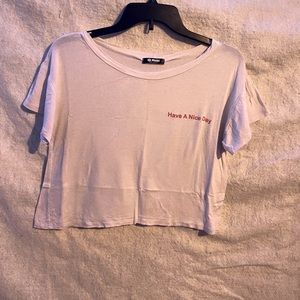 white, shear crop top with red lettering.